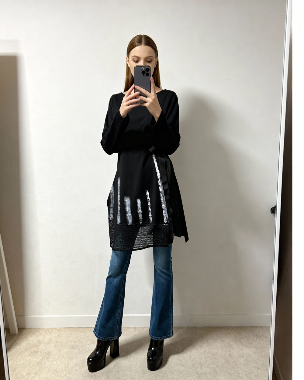 Model nosi crnu tuniku Zorka s ručno oslikanim bijelim detaljima i mrežastim donjim dijelom.